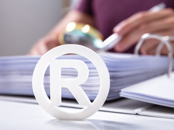 White Registered Trademark Sign Near Documents