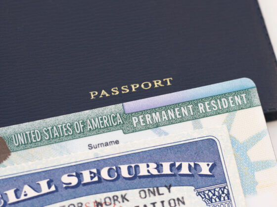 United States passport, social security card and permanent resident (green) card on white background. Immigration concept